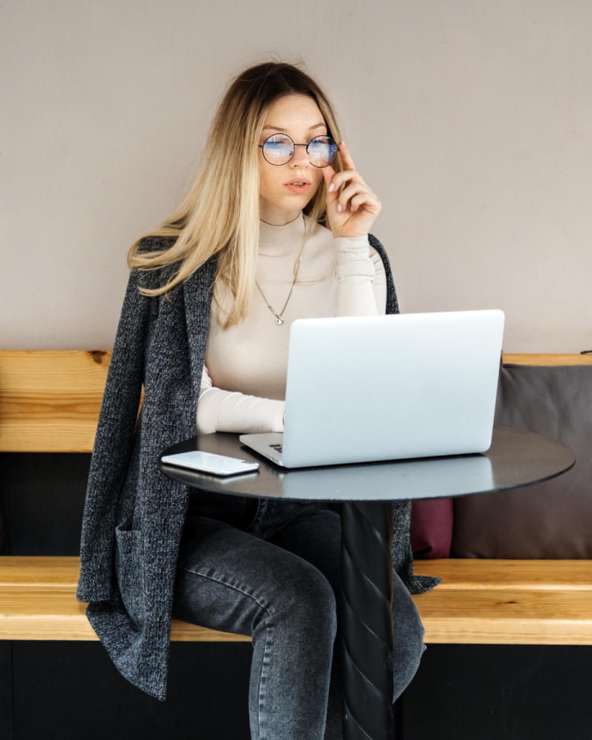 Young professional working on a laptop in a cafe — accounting student